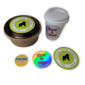 Assorted custom round stickers on a kraft food bowl, white takeaway cup, and shown separately — designs include “Thank you” gorilla logo, “Glow & Flow,” and “Feeling Cute”
